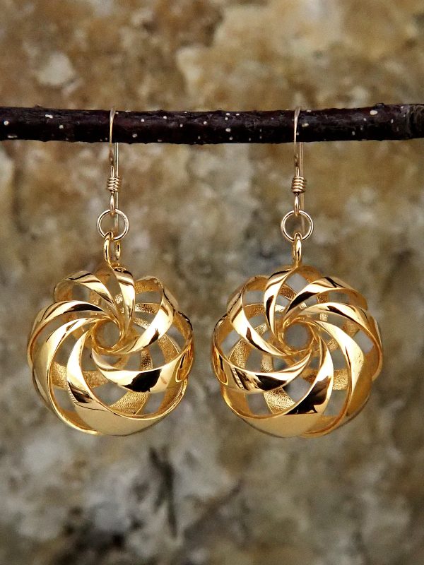 Gold-plated brass earrings shaped like diagonally-banded tori