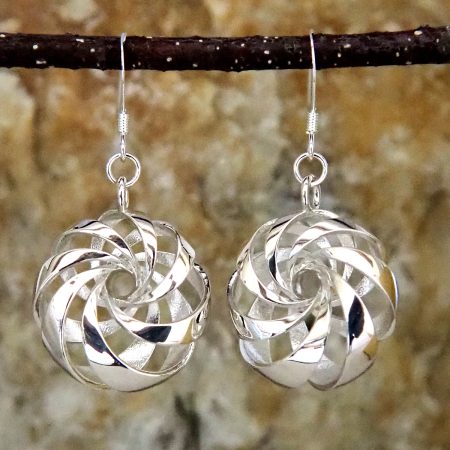 Sterling silver earrings shaped like diagonally-banded tori