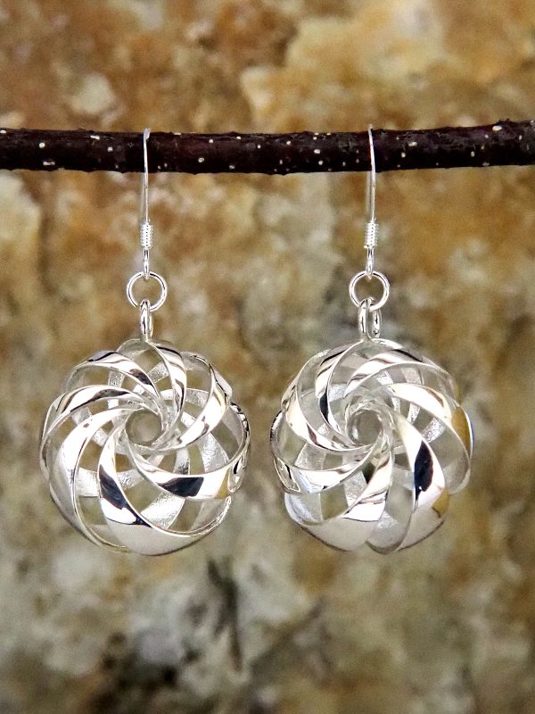 Sterling silver earrings shaped like diagonally-banded tori