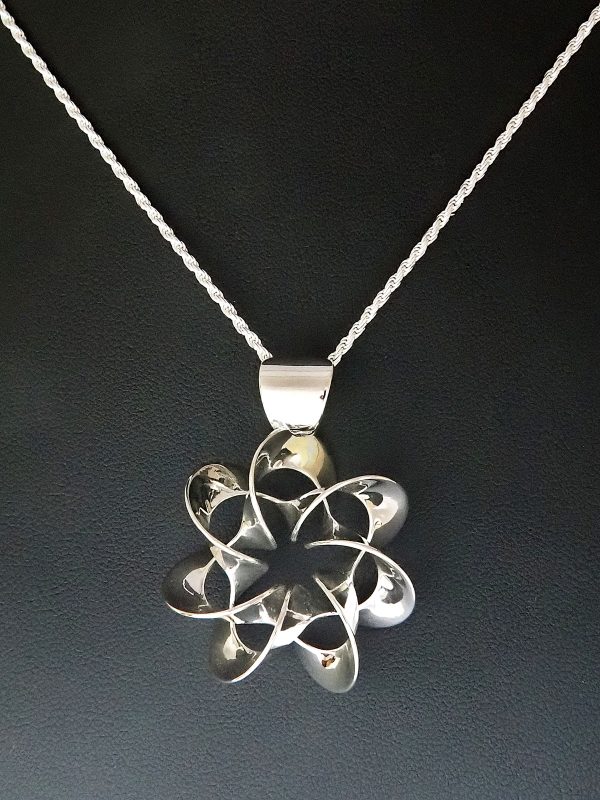 A flower-like polished silver pendant on a silver chain