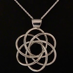 Harmonia, a flower-like sterling silver pendant with 6-fold symmetry.